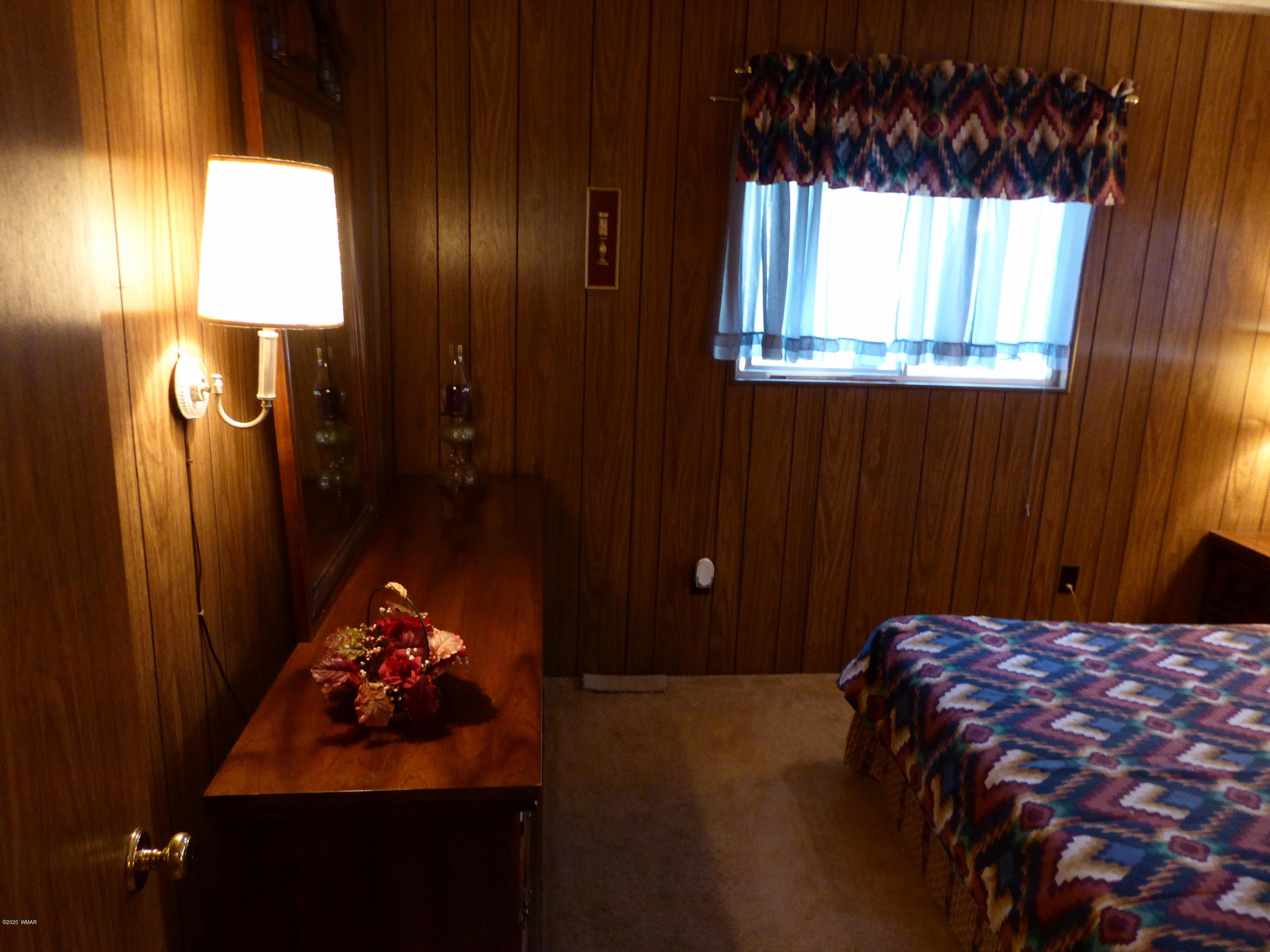 2898 Belle Road Overgaard, AZ 85933 - Photo 18 of 26 a bedroom with a bed and a dresser