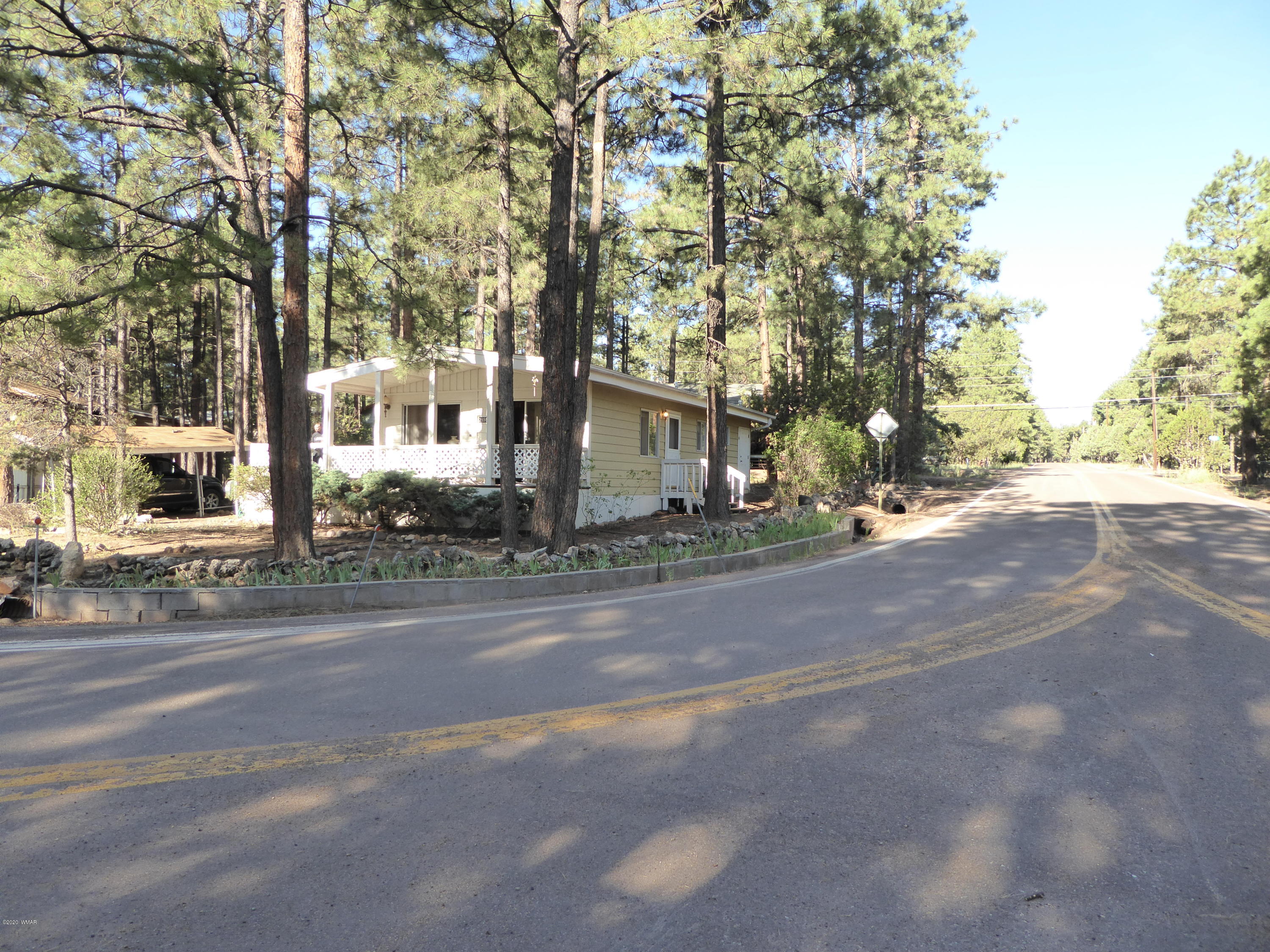 2898 Belle Road Overgaard, AZ 85933 - Photo 20 of 26 front view of a house with a trees