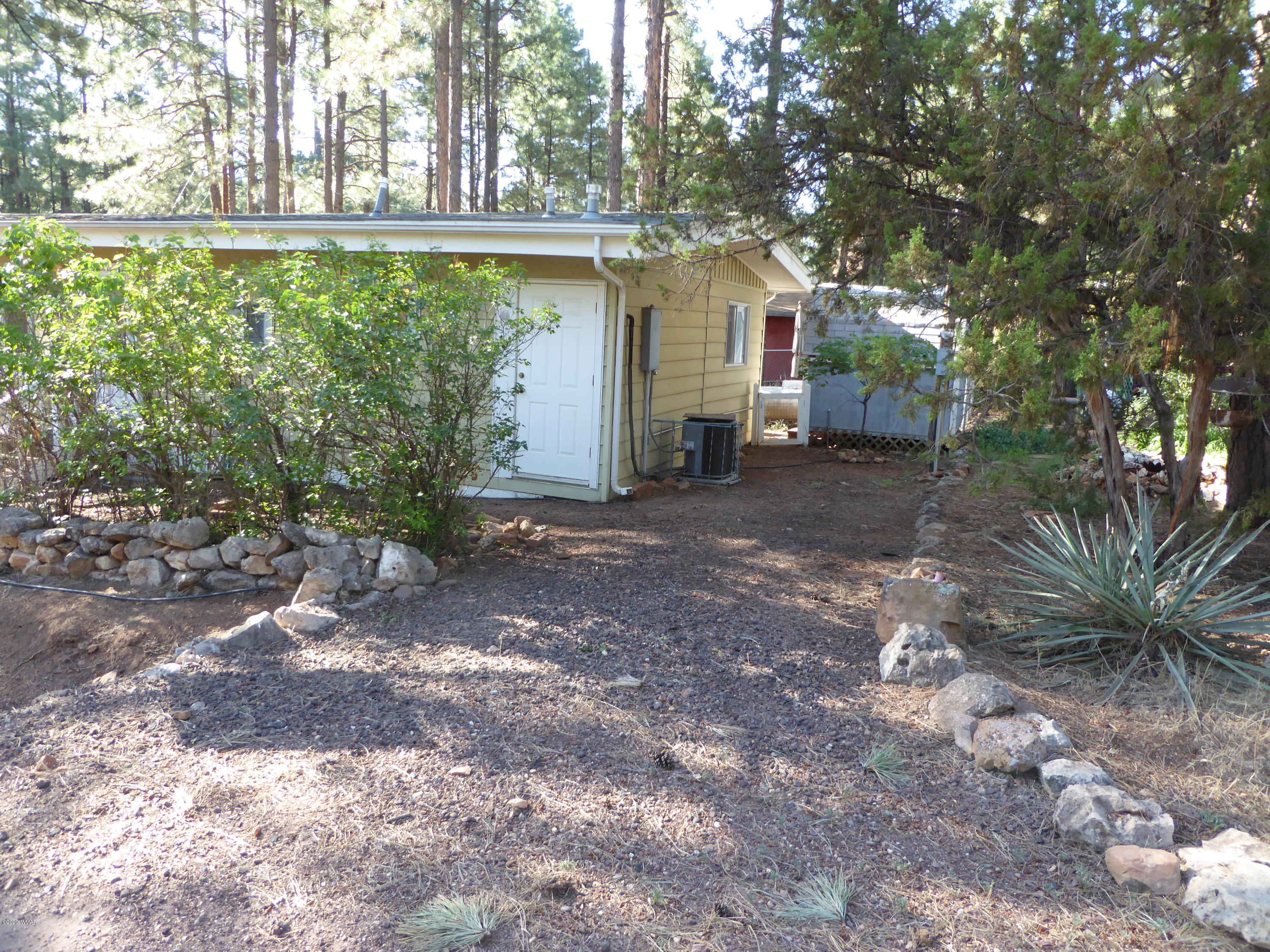 2898 Belle Road Overgaard, AZ 85933 - Photo 23 of 26 a view of a backyard with large trees
