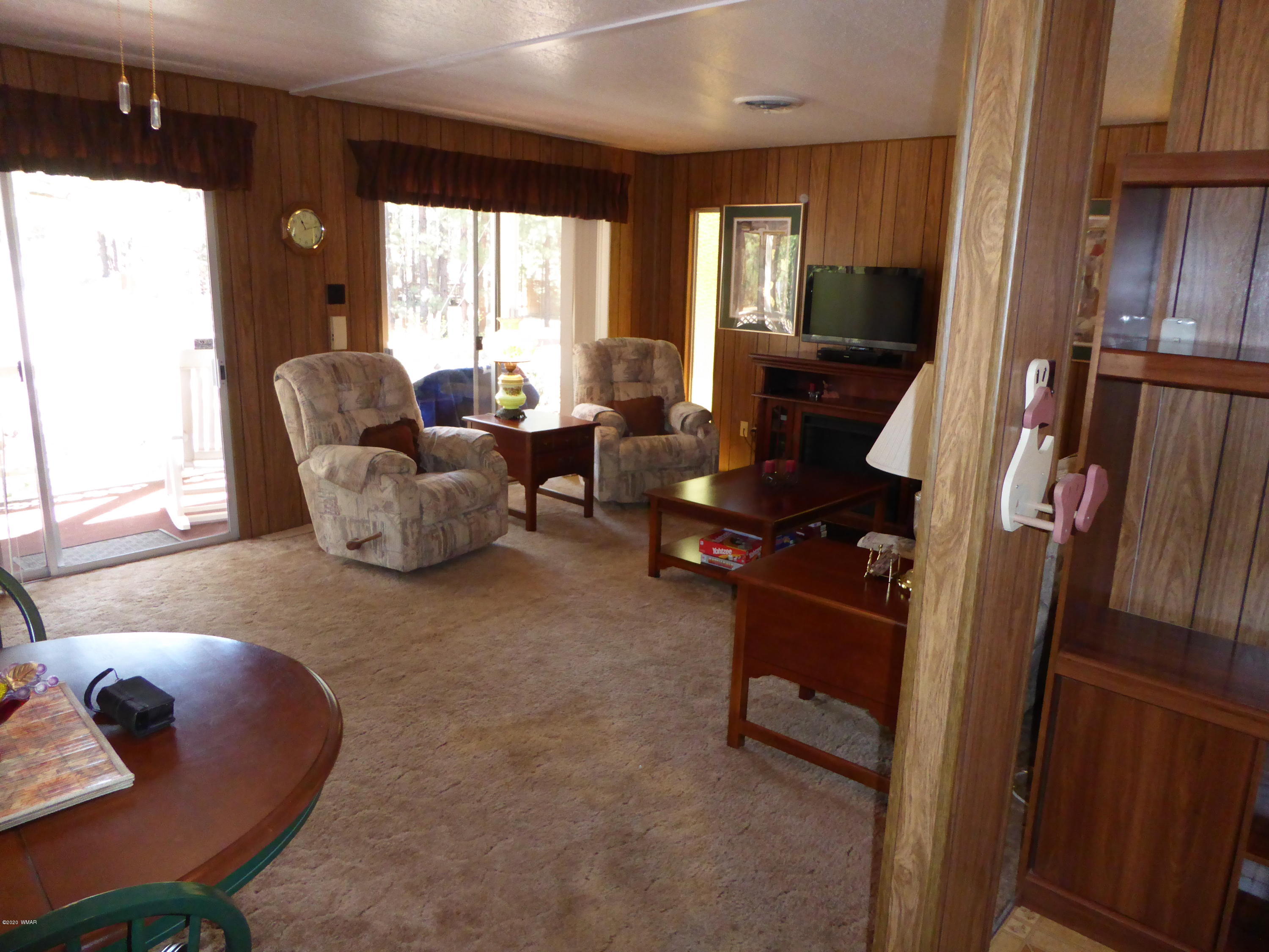 2898 Belle Road Overgaard, AZ 85933 - Photo 5 of 26 a living room with furniture and a large window