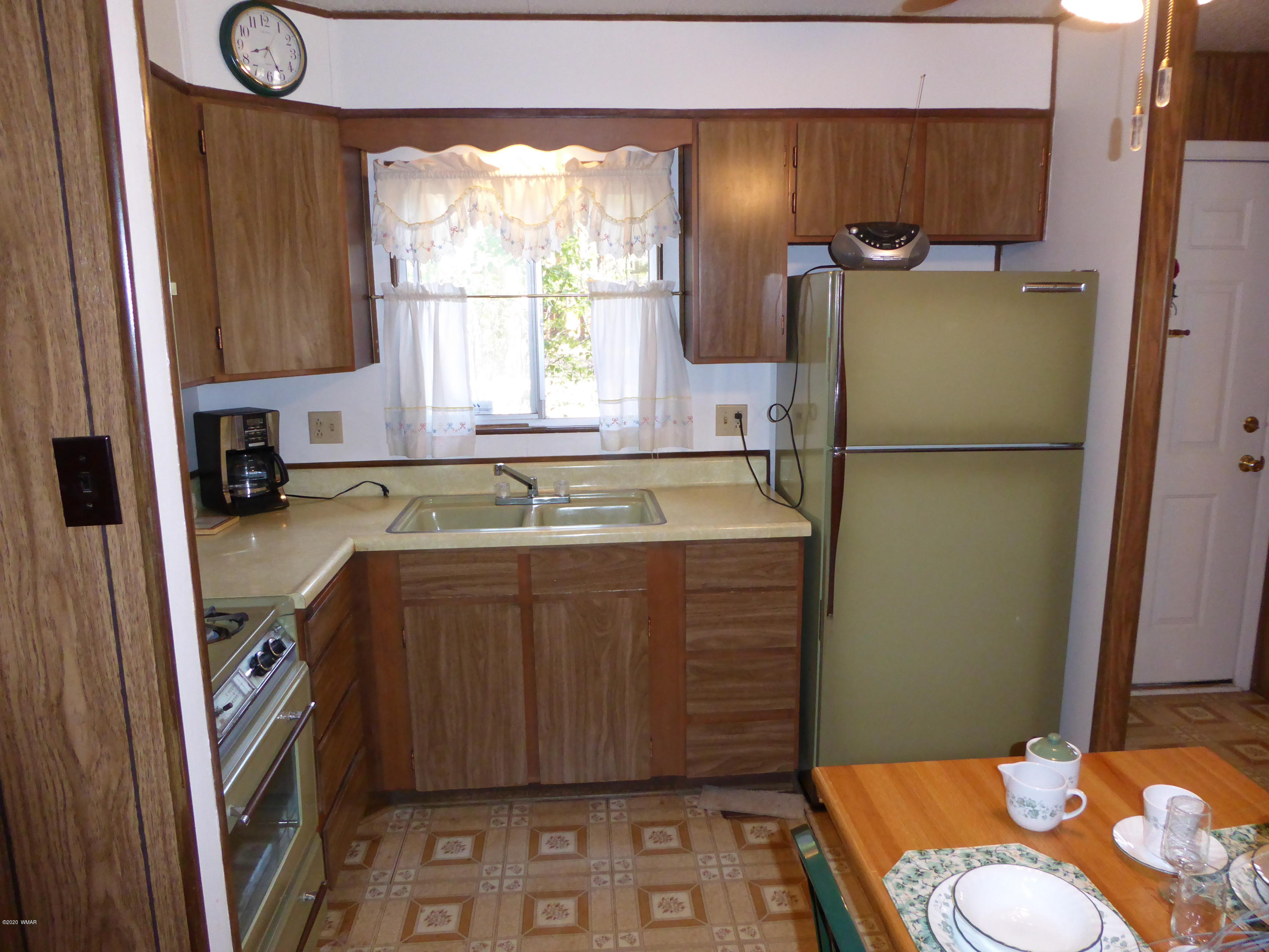2898 Belle Road Overgaard, AZ 85933 - Photo 6 of 26 a kitchen with a sink a refrigerator and a stove