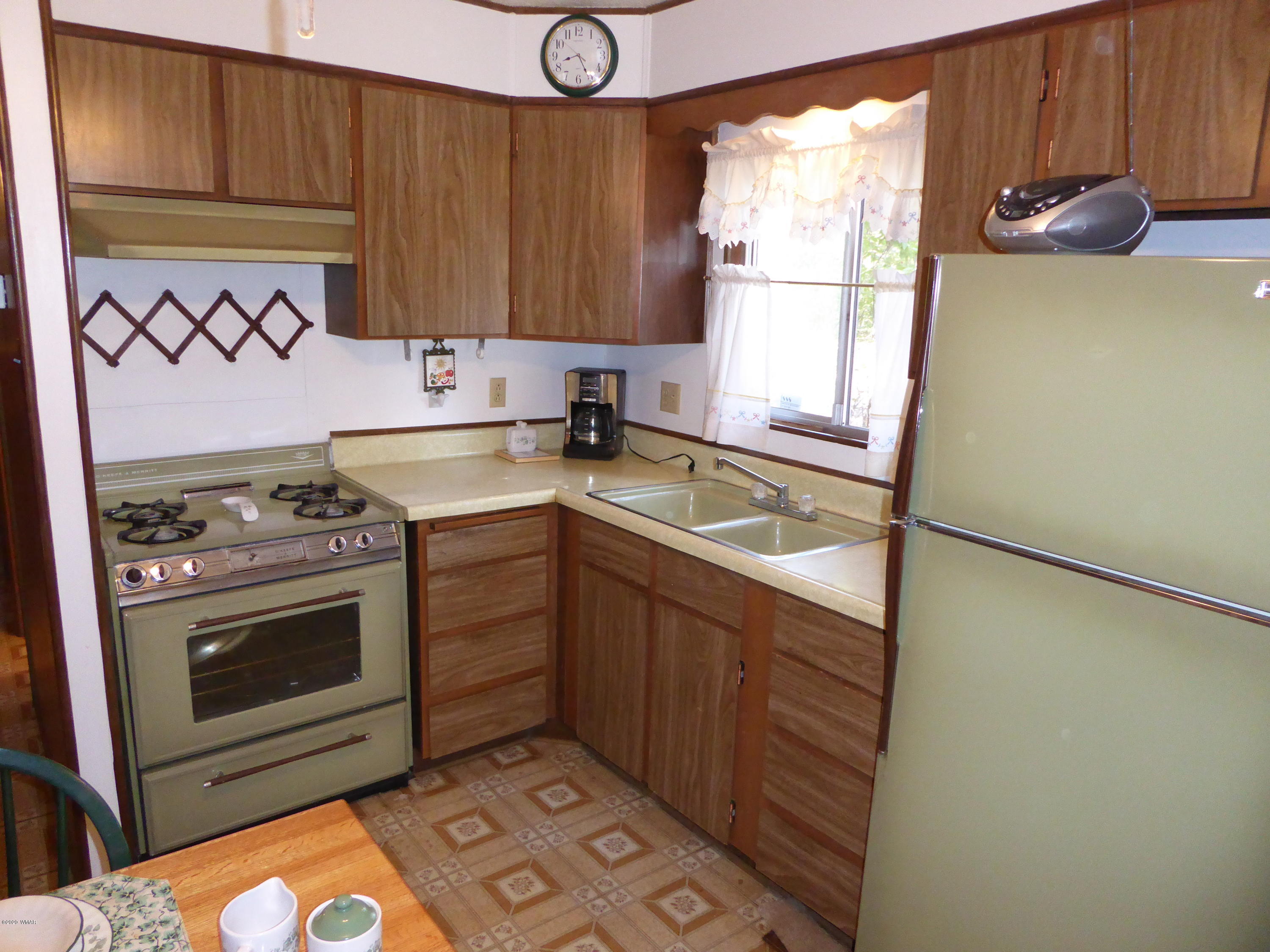 2898 Belle Road Overgaard, AZ 85933 - Photo 7 of 26 a kitchen with a stove a sink and a window