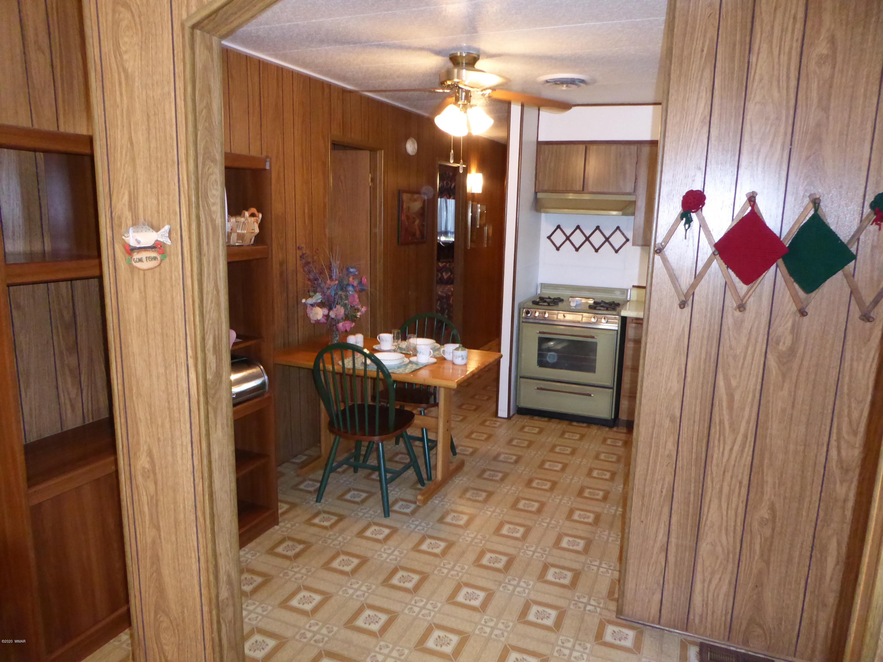 2898 Belle Road Overgaard, AZ 85933 - Photo 8 of 26 a kitchen with a sink stove and refrigerator