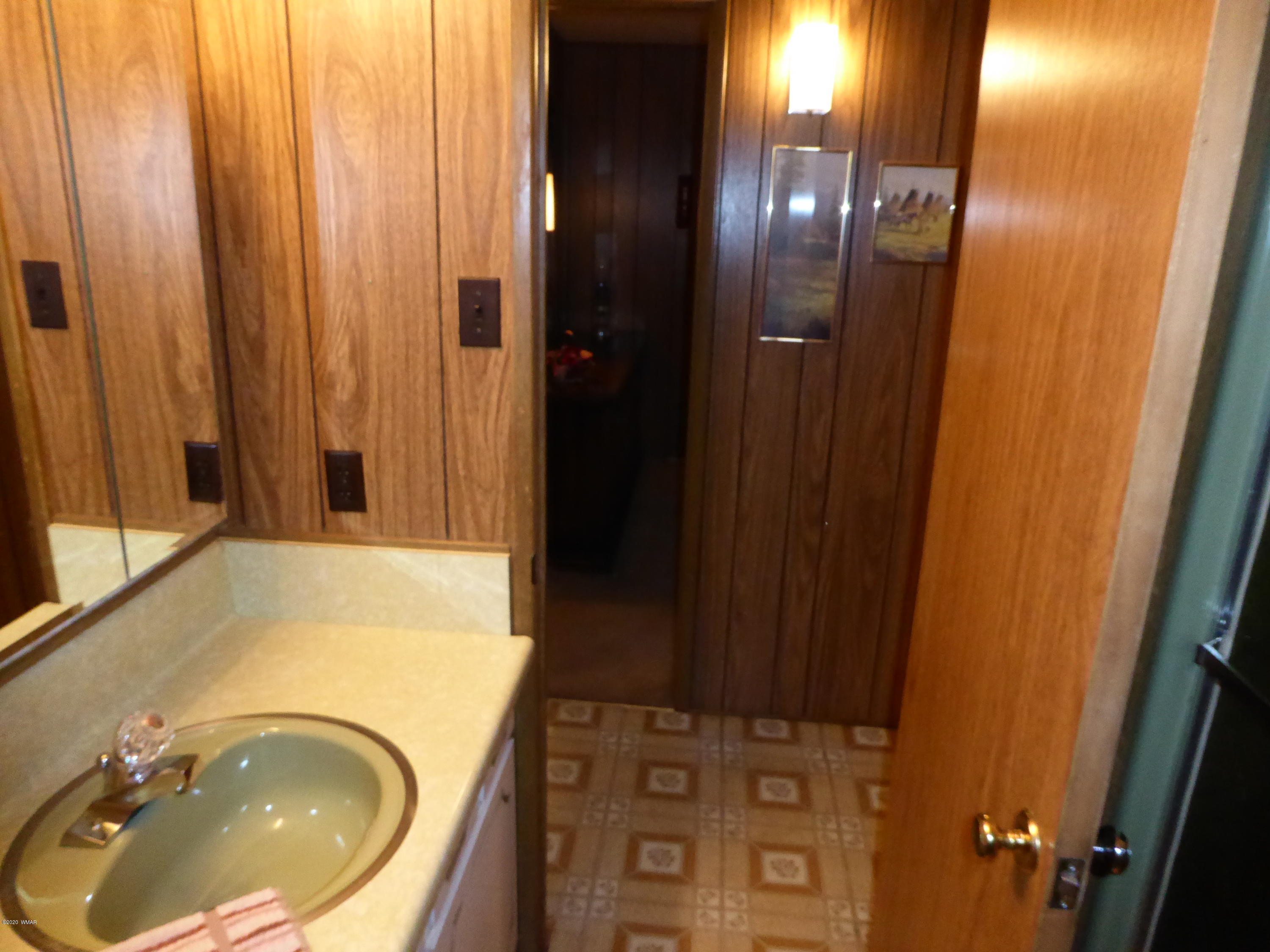2898 Belle Road Overgaard, AZ 85933 - Photo 10 of 26 a bathroom with a sink and a mirror