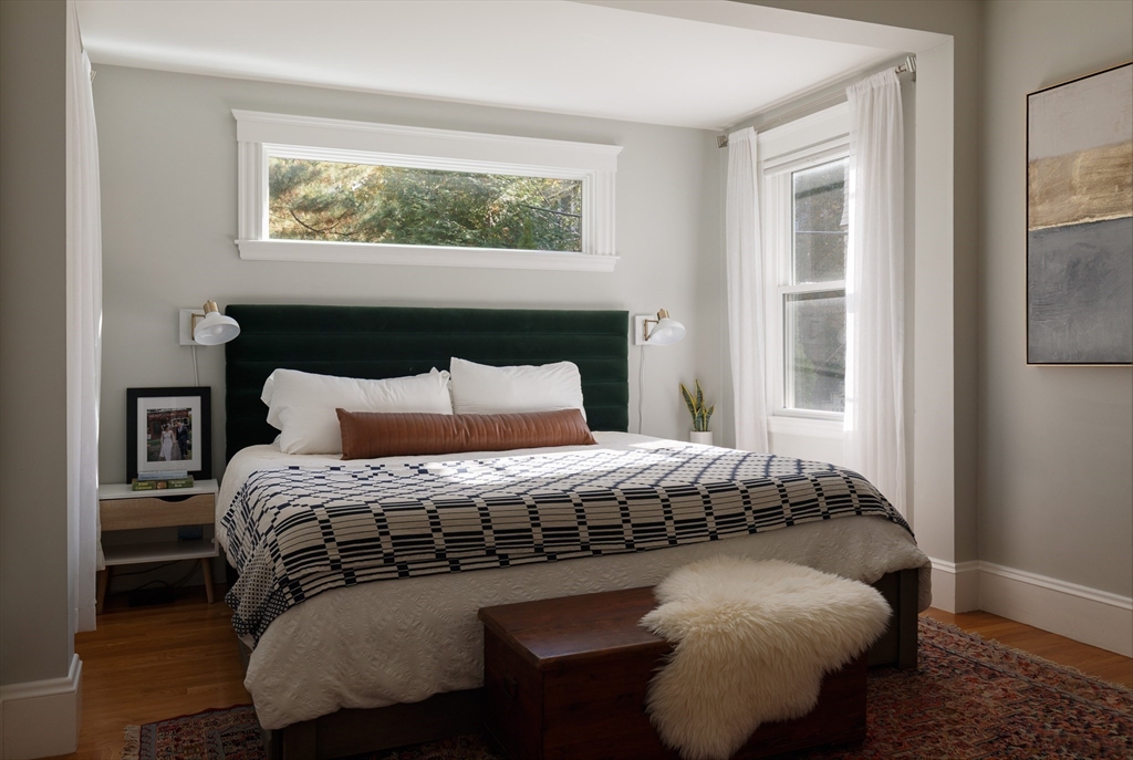 107 Grozier Road, Unit 1 Cambridge, MA 02138 - Photo 12 of 23 a bed sitting in a bedroom next to a window