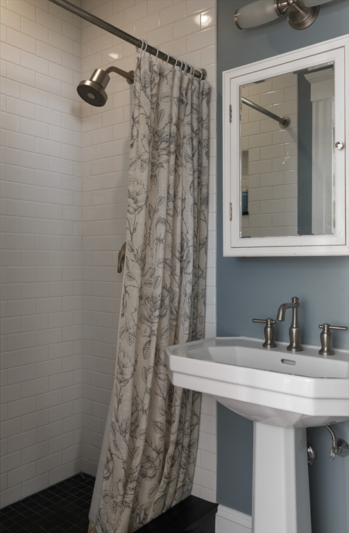107 Grozier Road, Unit 1 Cambridge, MA 02138 - Photo 13 of 23 a bathroom with a sink and mirror