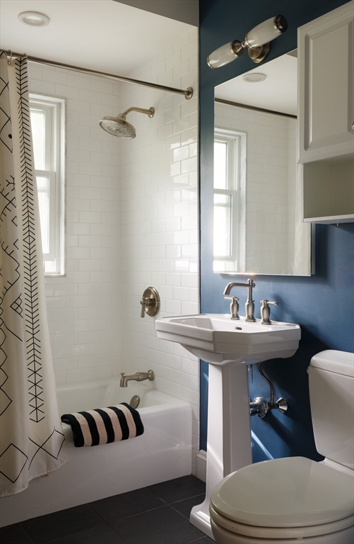 107 Grozier Road, Unit 1 Cambridge, MA 02138 - Photo 15 of 23 a bathroom with a sink a toilet and a mirror