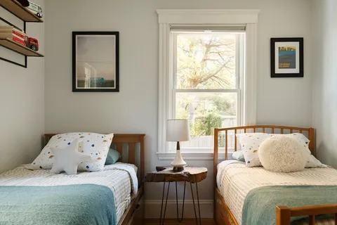 a bedroom with a bed and a window