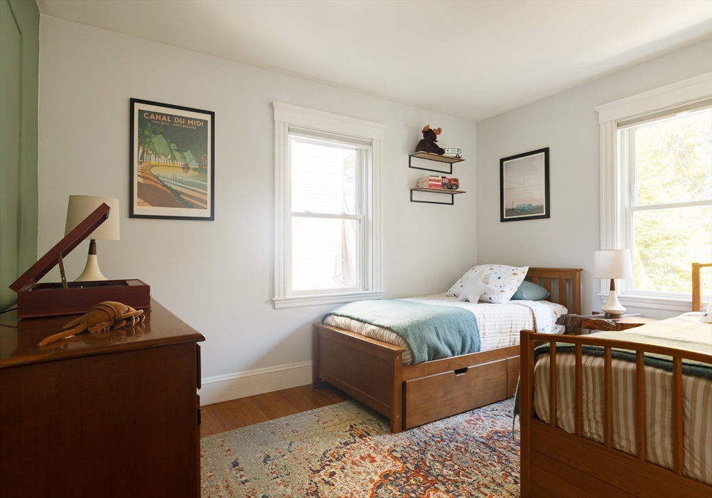 107 Grozier Road, Unit 1 Cambridge, MA 02138 - Photo 17 of 23 a bedroom with furniture and a window