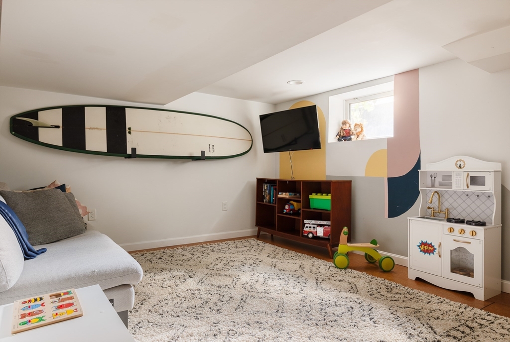 107 Grozier Road, Unit 1 Cambridge, MA 02138 - Photo 18 of 23 a living room with furniture and a flat screen tv