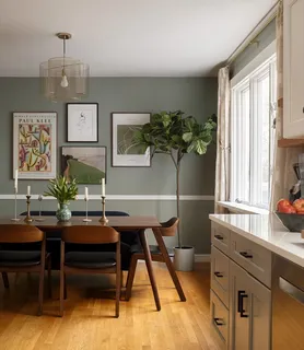 a view of a workspace room with furniture and a window