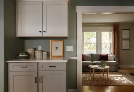 a living room with furniture a dining table and a window