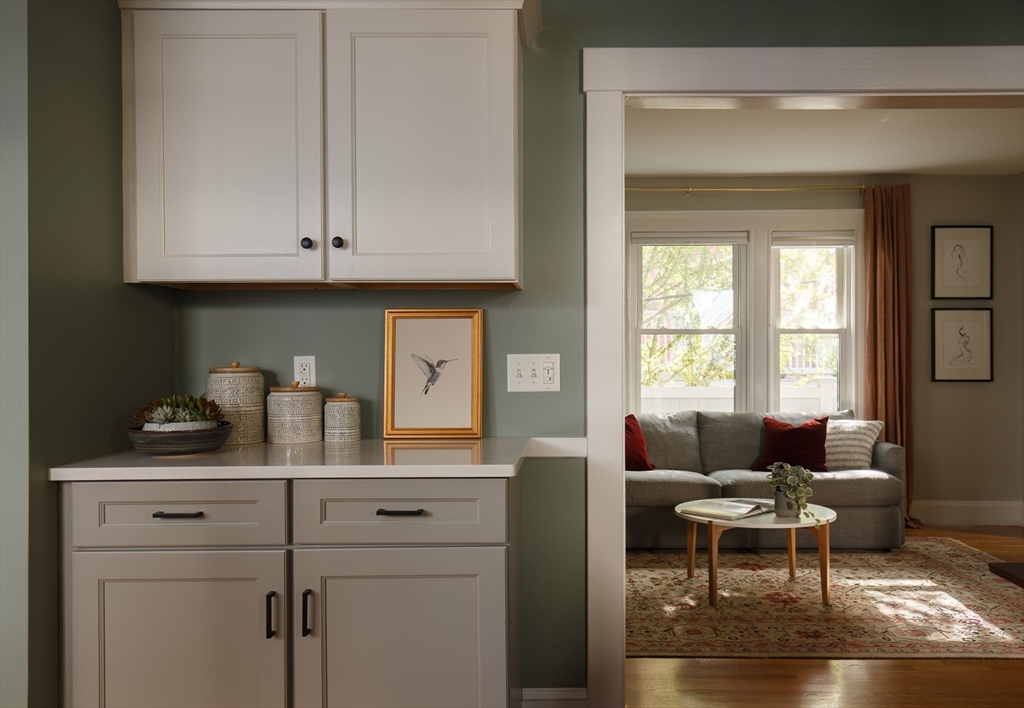 107 Grozier Road, Unit 1 Cambridge, MA 02138 - Photo 7 of 23 a living room with furniture a dining table and a window