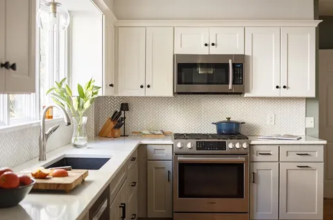 a kitchen with stainless steel appliances white cabinets and a stove