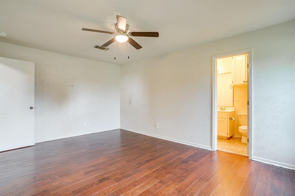709 North Ave B Springtown, TX 76082 - Photo 25 of 32 an empty room with wooden floor and windows