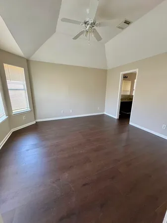 view of wooden floor and chair in a room