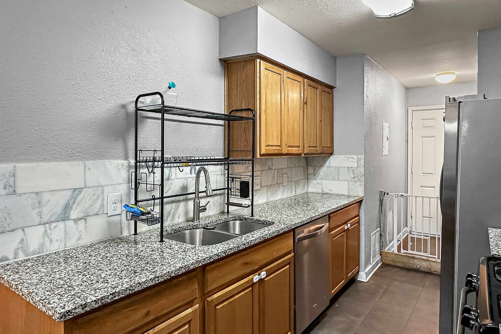700 Misty Morning Way Round Rock, TX 78664 - Photo 28 of 36 Unit A - A functional kitchen boasts granite counters, stainless steel appliances, and wood cabinetry.