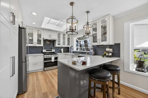 a kitchen with a sink stove and cabinets