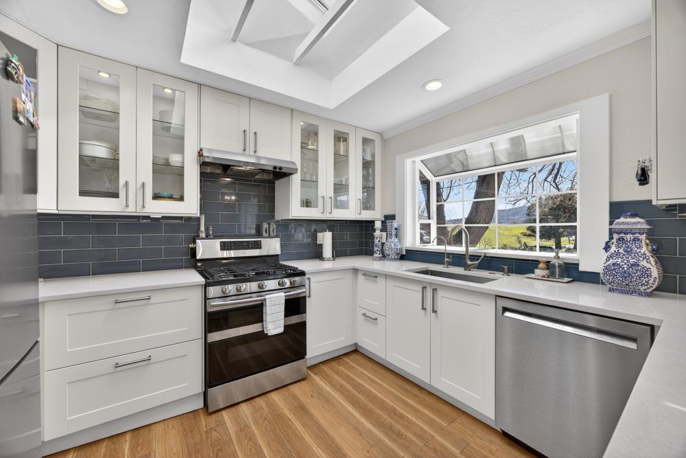 20690 County Road 79B Capay, CA 95607 - Photo 23 of 96 a kitchen with stainless steel appliances granite countertop a stove and cabinets