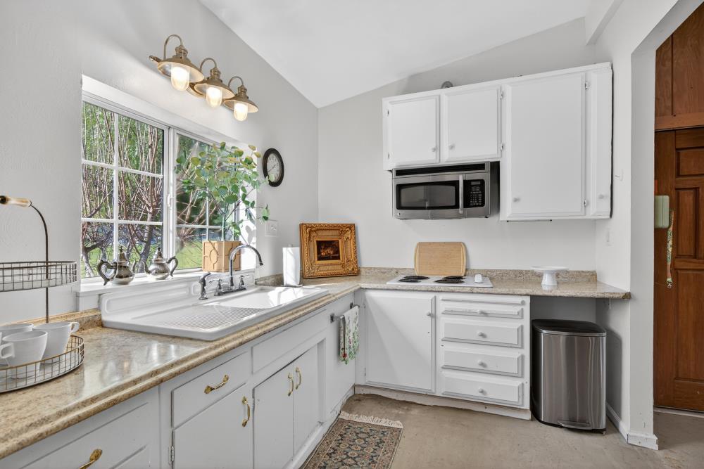 20690 County Road 79B Capay, CA 95607 - Photo 71 of 96 a kitchen with a sink stove and microwave