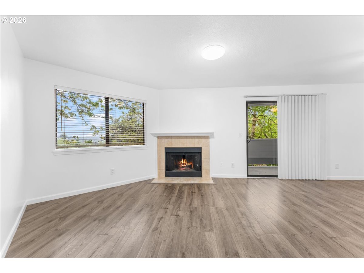 10160 Southeast Talbert Street Clackamas, OR 97015 - Photo 15 of 25 a view of an empty room with a window and fireplace