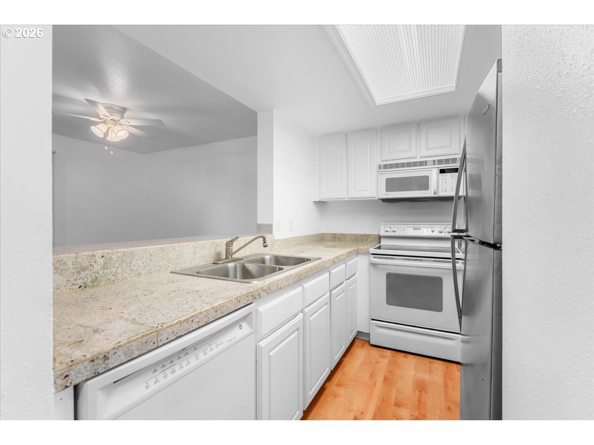 10160 Southeast Talbert Street Clackamas, OR 97015 - Photo 17 of 25 a kitchen with a sink appliances and cabinets