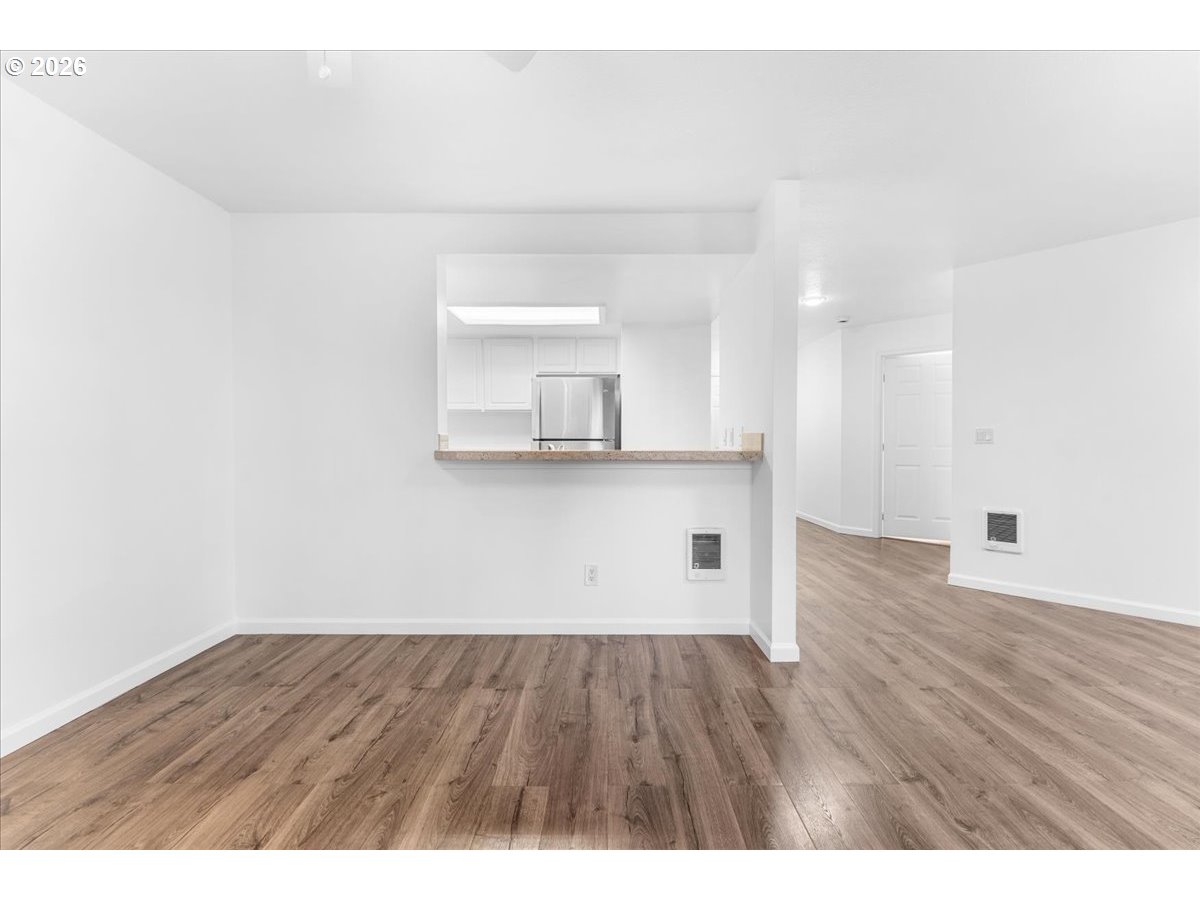 10160 Southeast Talbert Street Clackamas, OR 97015 - Photo 6 of 25 a view of a kitchen with wooden floor and a sink