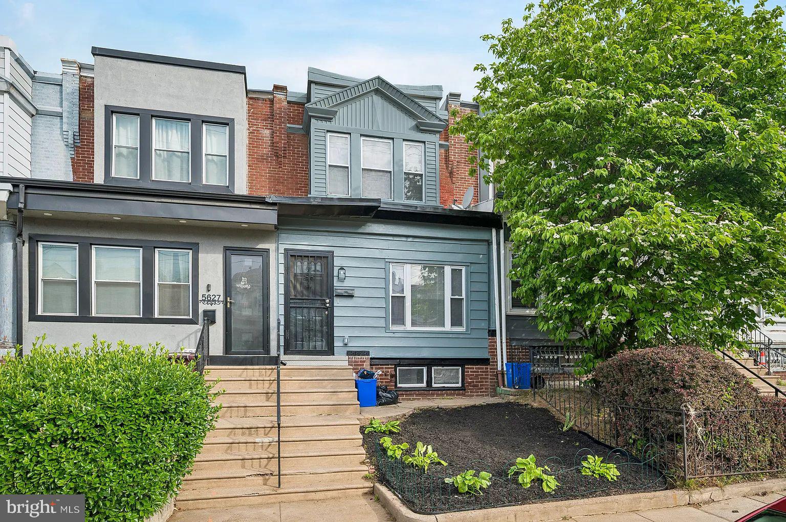 5625 Willows Avenue Philadelphia, PA 19143 - Photo 1 of 15 a front view of a house with a garden and plants