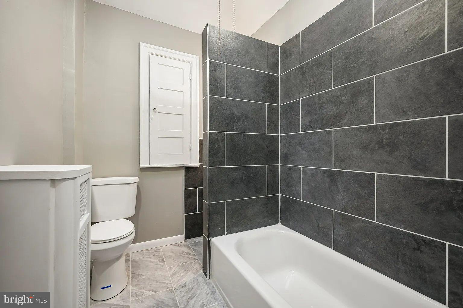 5625 Willows Avenue Philadelphia, PA 19143 - Photo 8 of 15 a bathroom with a toilet and a bath tub
