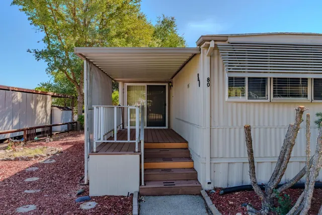 a view of a patio with table and chairs