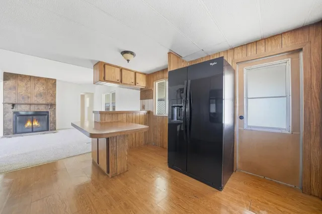 a kitchen with stainless steel appliances granite countertop a refrigerator and cabinets