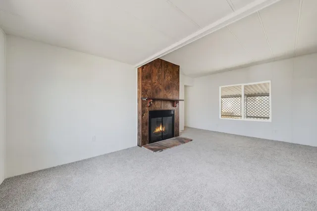 a view of a livingroom with workspace and a window