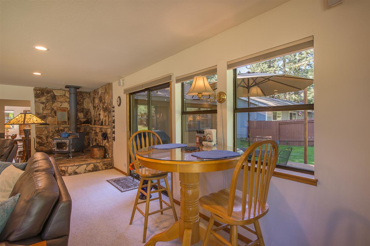 11202 Bishop Pine Road Truckee, CA 96161 - Photo 14 of 21 a dining room with furniture floor to ceiling windows and a rug