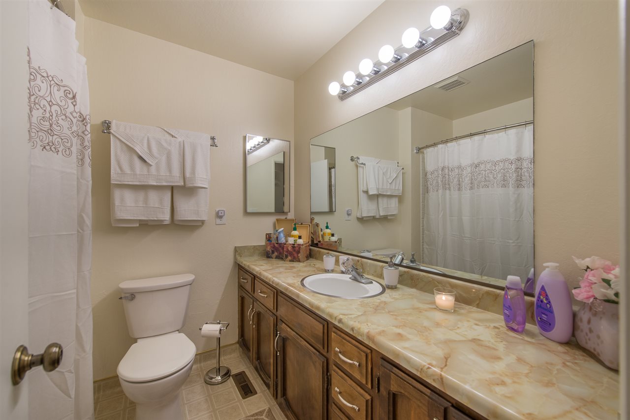 11202 Bishop Pine Road Truckee, CA 96161 - Photo 16 of 21 a bathroom with a granite countertop sink a toilet and a mirror