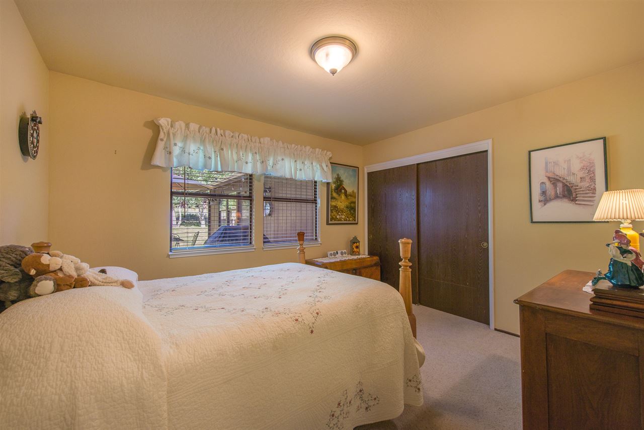 11202 Bishop Pine Road Truckee, CA 96161 - Photo 18 of 21 a bedroom with a large bed and a chandelier