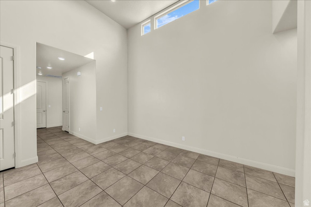 794 North Via Modelo Circle Washington, UT 84780 - Photo 18 of 21 Empty room with a high ceiling, recessed lighting, and light tile patterned flooring