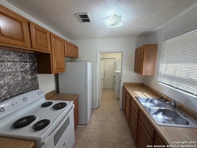 a kitchen with a stove and a refrigerator
