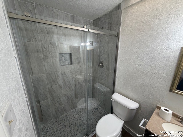 202 Ash Drive, Unit 104 Converse, TX 78109 - Photo 9 of 10 a bathroom with a toilet and a shower