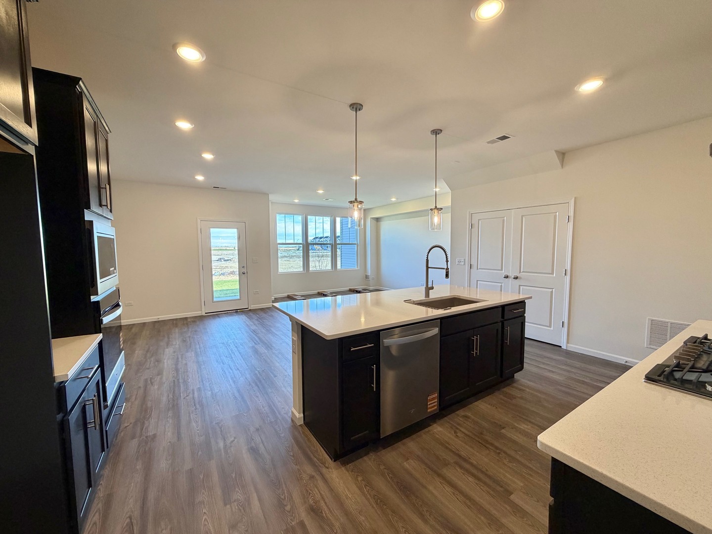704 Switchgrass Way Bolingbrook, IL 60490 - Photo 3 of 14 a kitchen with wooden floors and sink