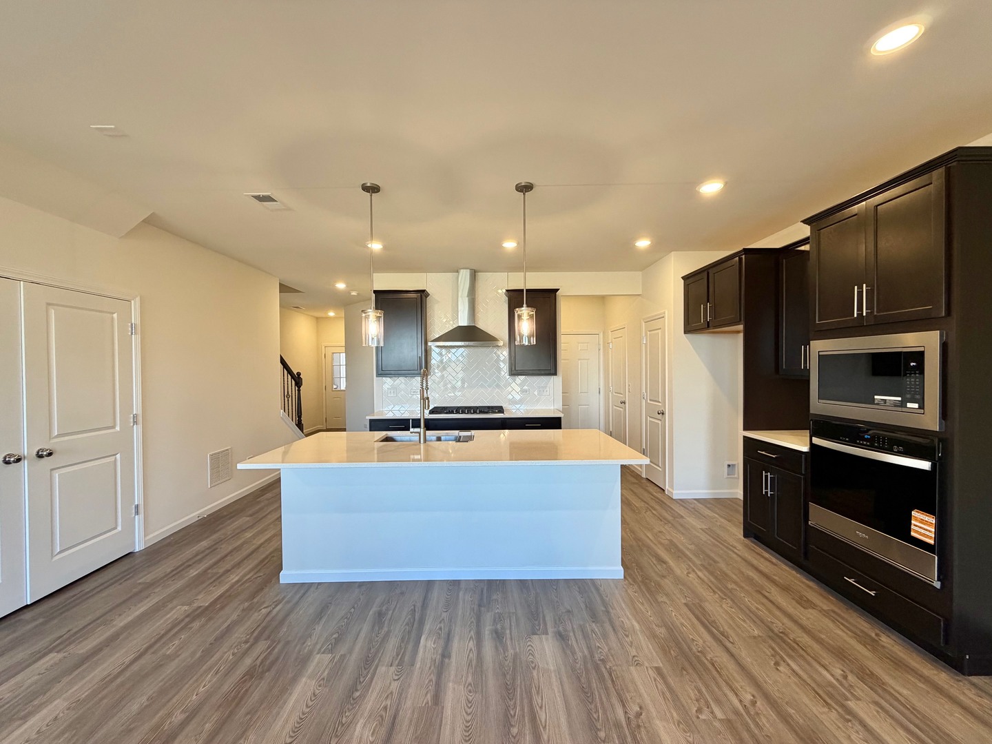 704 Switchgrass Way Bolingbrook, IL 60490 - Photo 4 of 14 a large kitchen with stainless steel appliances a large counter top and a stove