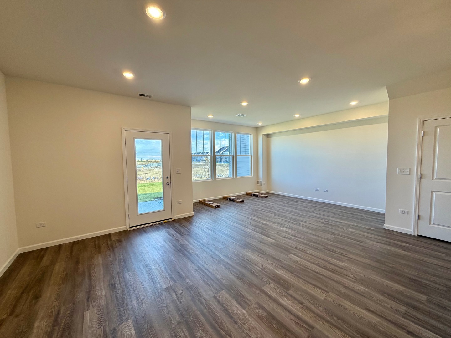 704 Switchgrass Way Bolingbrook, IL 60490 - Photo 6 of 14 a view of empty room with wooden floor and fan
