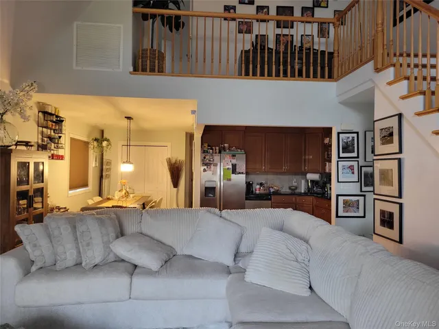 a living room with furniture and a kitchen