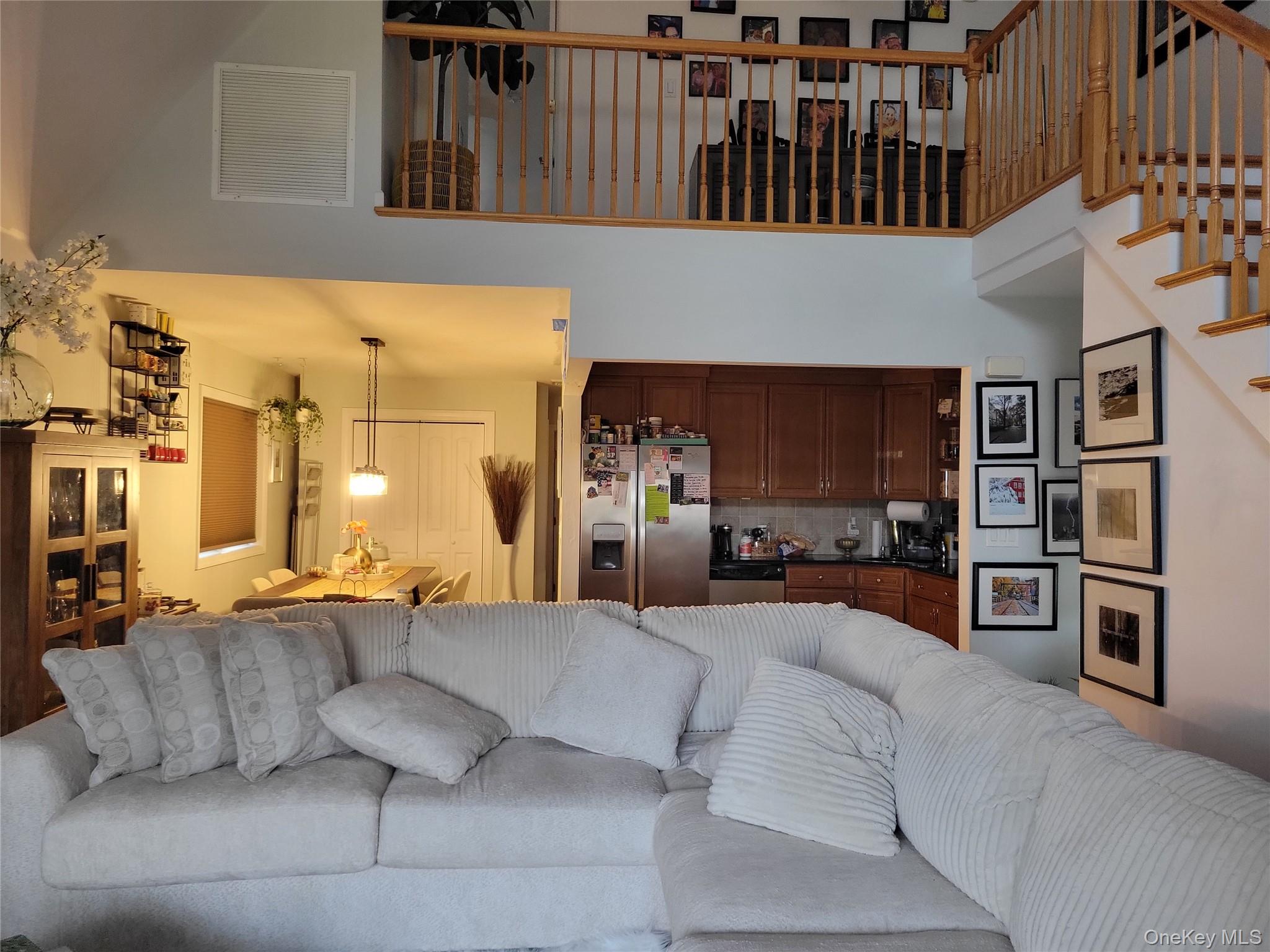 61-40 173rd Street Queens, NY 11365 - Photo 3 of 9 a living room with furniture and a kitchen