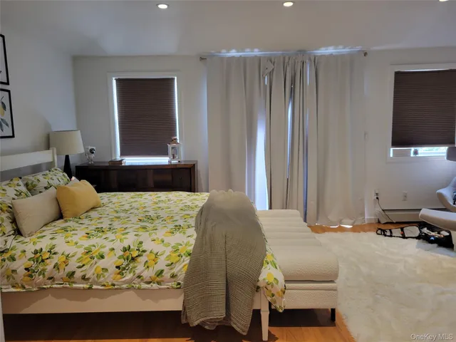 a bedroom with a bed and flat screen tv