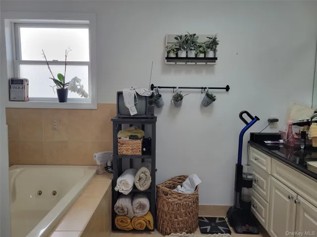 a bathroom with a bathtub and a window