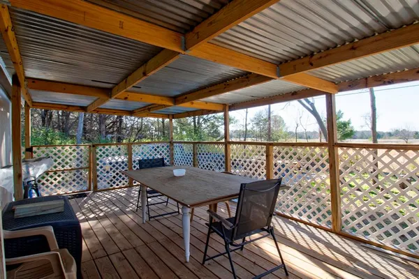 a view of a patio with wooden floor
