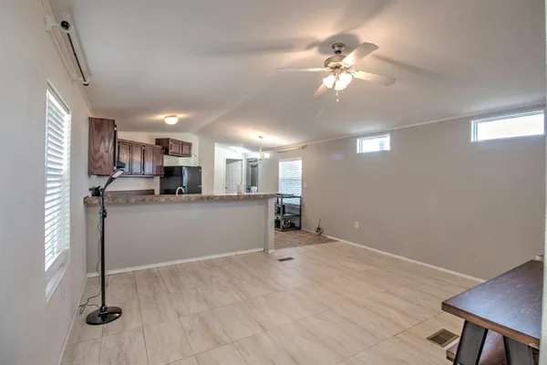 a view of a kitchen with furniture and a ceiling fan