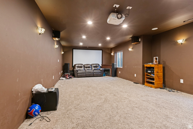 4557 North Ranch Road East Tooele, UT 84074 - Photo 24 of 43 Projector with ceiling mount, recessed lighting, wall-mounted sconces, and a large projection screen
