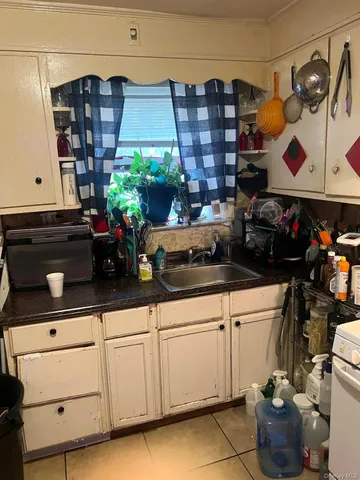 a kitchen with stainless steel appliances a refrigerator a stove and a cabinets