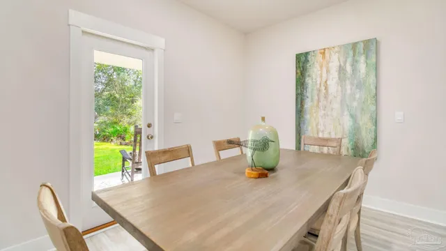a view of a dining room with a table and chairs